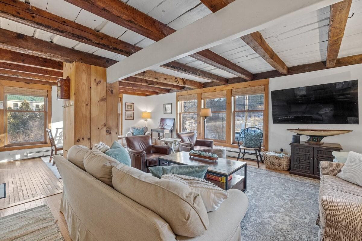 Living room with game table, reading nook, and large screen television